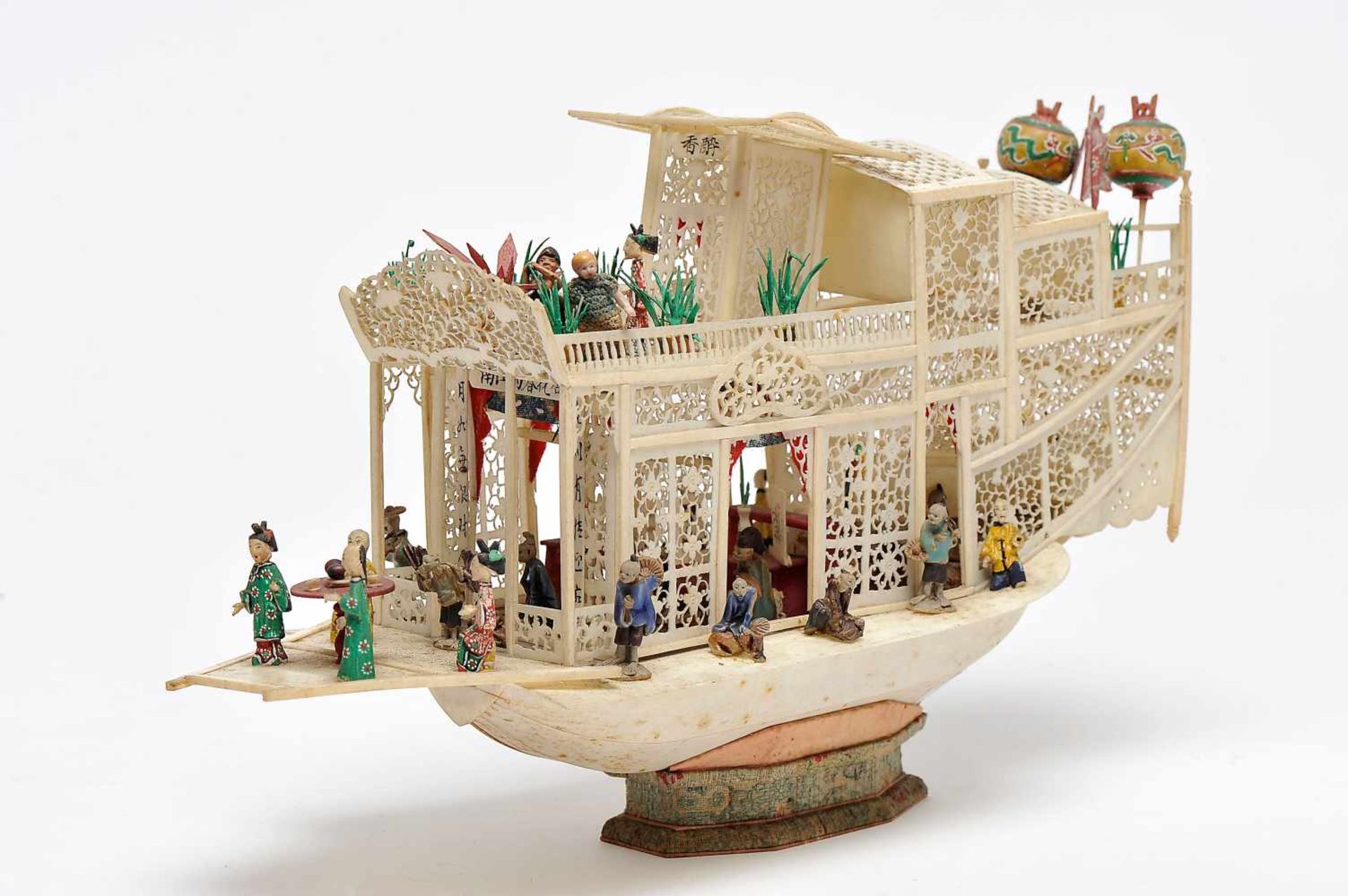 A Chinese Boat with Figures, set of ivory sculptures, pierced and partly polychrome decoration,