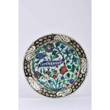 A Dish, faience, polychrome decoration "Flowers", the Isnik manner. Turkish, 19th C., chips, minor