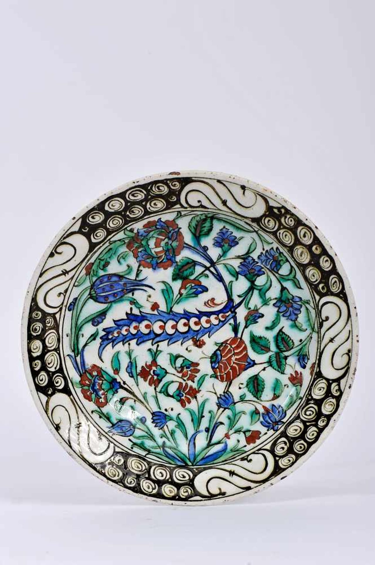 A Dish, faience, polychrome decoration "Flowers", the Isnik manner. Turkish, 19th C., chips, minor