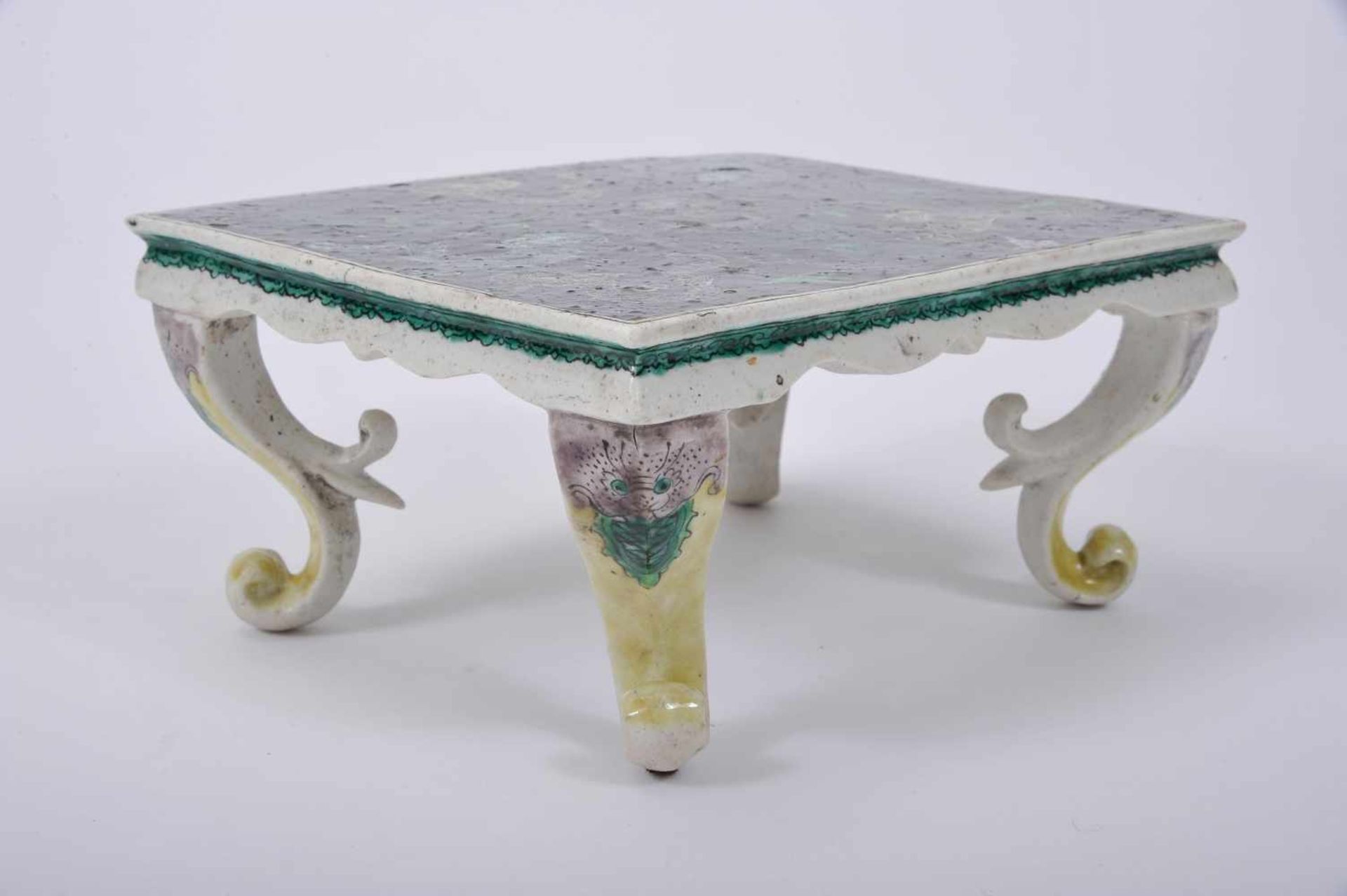 A Miniature table, partly glazed biscuit, «Famille Verte» decoration "Dragons", Kangxi period (