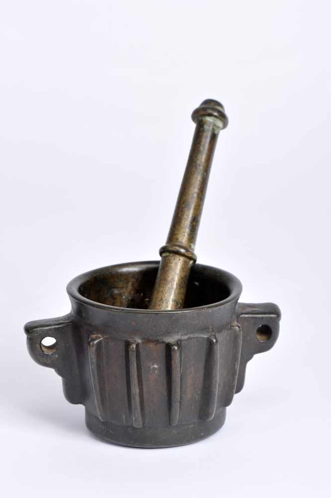 A Mortar with Pestle, gothic, bronze, ribbed decoration en relief, two spikes with holes for