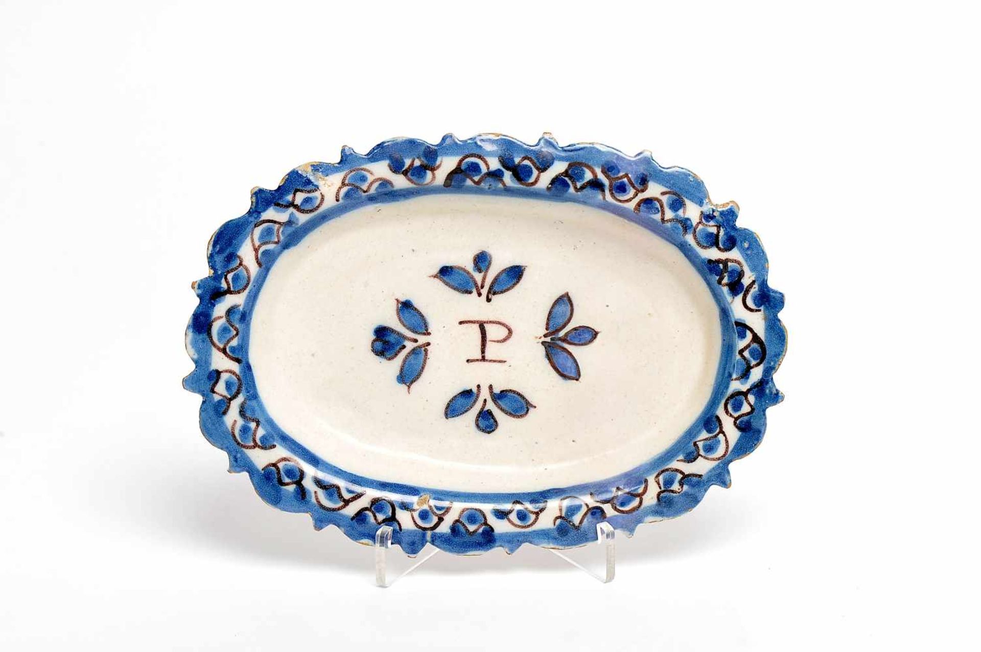 A Scalloped Platter, faience, blue and vinous "Beaded" decoration, central decoration with