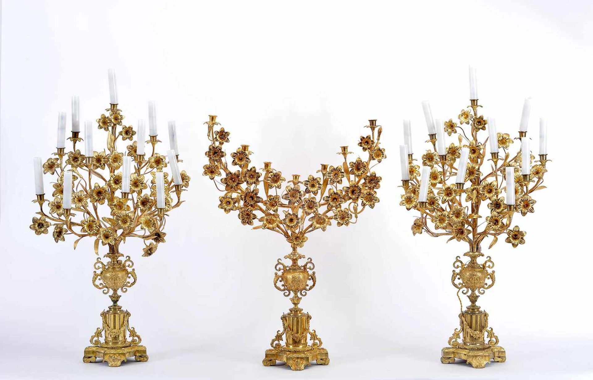 Three Church Candelabra (two with Twelve-light and one with Seven-light), gilt and chiselled