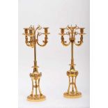 A Pair of Three-light Candelabra, Empire style, chiselled and gilt bronze "Winged sphinxes and