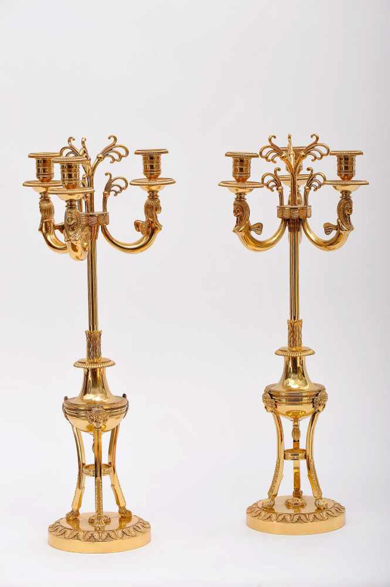 A Pair of Three-light Candelabra, Empire style, chiselled and gilt bronze "Winged sphinxes and