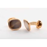 A Pair of PATEK PHILIPPE cuff links - ELLIPSE model, 750/1000 gold, set with sapphire glass,