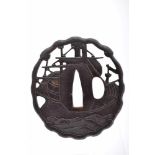 A Tsuba (sword guard), Namban Art, pierced iron en relief with traces of gilding "The Black