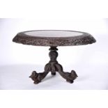 A Table, sissoo, fully carved and pierced decoration "Flowers", tilt-top, zoomorphic feet, Goan,