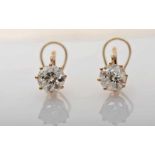 A Pair of Earrings, 750/1000 gold, set with 2 antique brilliant cut diamonds with an approximate