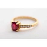 A Ring, 800/1000 gold, set with an oval cut ruby with an approximate weight of 1.50 ct. and 10
