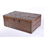 A Large Chest, teak, carved cover's front, straps, iron hinges and locks with metal studs en relief,