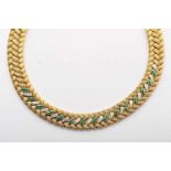 A Necklace, 800/1000 gold, set with 45 calibrated emeralds and 45 baguette cut diamonds with an
