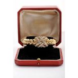 A RÉGNER wristwatch, 750/1000 gold rigid case and bracelet, set with 50 brilliant cut diamonds