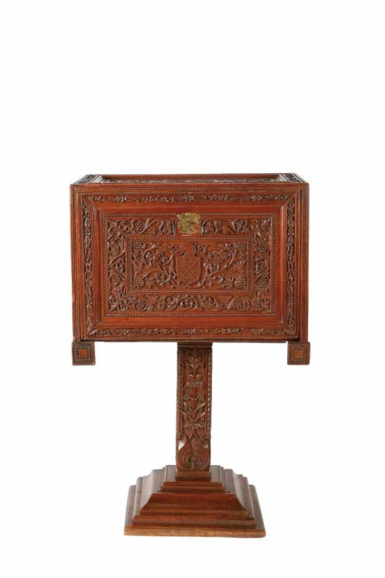 A writting cabinet on a single foot, Lusíada, carved teak decorated with foliate scrolls,