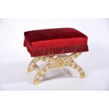 A Stool, Empire style, carved, painted a partly gilt walnut, X shaped frame with gilt carvings,