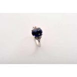 A Ring, 800/1000 gold, set with a cabochon cut sapphire with an approximate weight of 5.50 ct. and 6