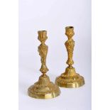 A Pair of Candlesticks, Louis XV style, gilt bronze en relief, French, 19th C., missing candle-
