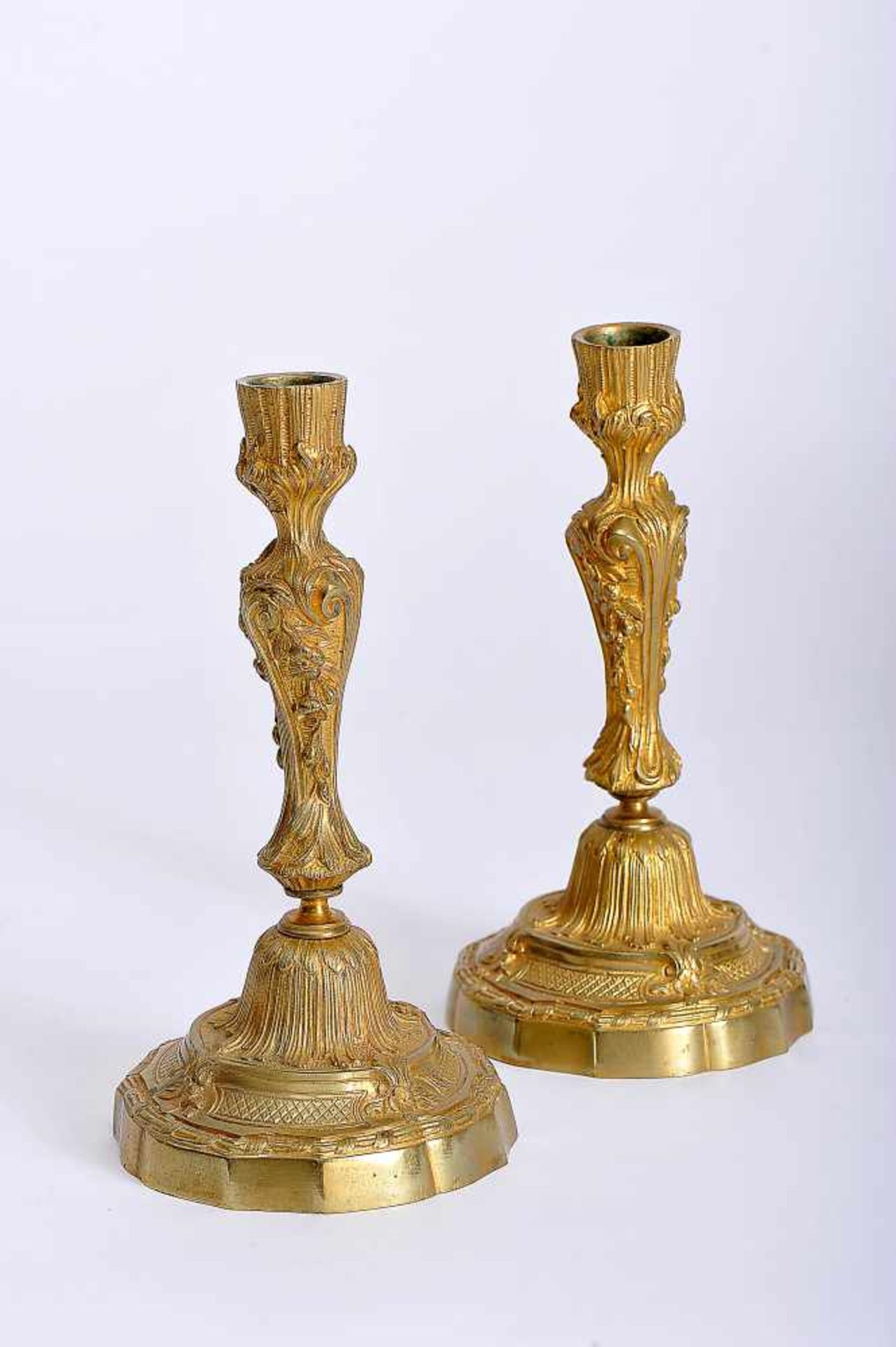 A Pair of Candlesticks, Louis XV style, gilt bronze en relief, French, 19th C., missing candle-