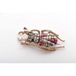 A Brooch - "Beetle", gold and silver, set with 11 rubies, rose and crowned rose cut diamonds and