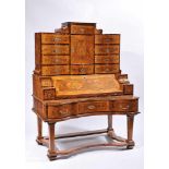 A Bureau, walnut and burr-walnut, upper body with ten drawers and central door, satinwood fillets,