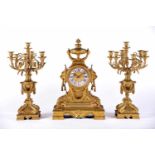 A Garniture - A Table Clock and a Pair of Seven-light Candelabra, Napoleon III, chiselled and gilt