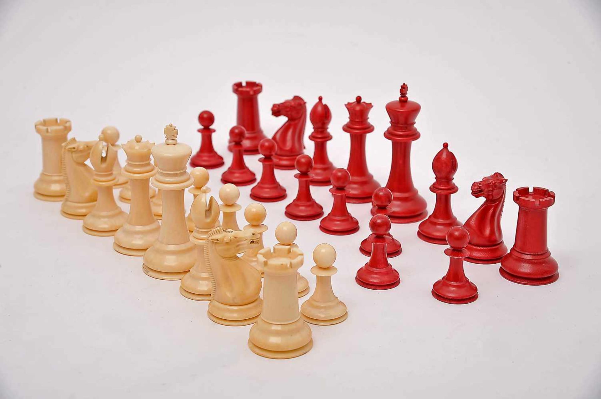 A JACQUES STAUNTON Chess Pieces - SIZE CLUB, carved ivory being one of the sets dyed red, mahogany