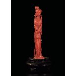 A carved coral figurine, China, early 1900s - Gross weight 158gr; H 14.5cm -