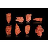 Eight carved coral pendants, China, early 1900s - 338gr; from 5.5cm to 8cm -