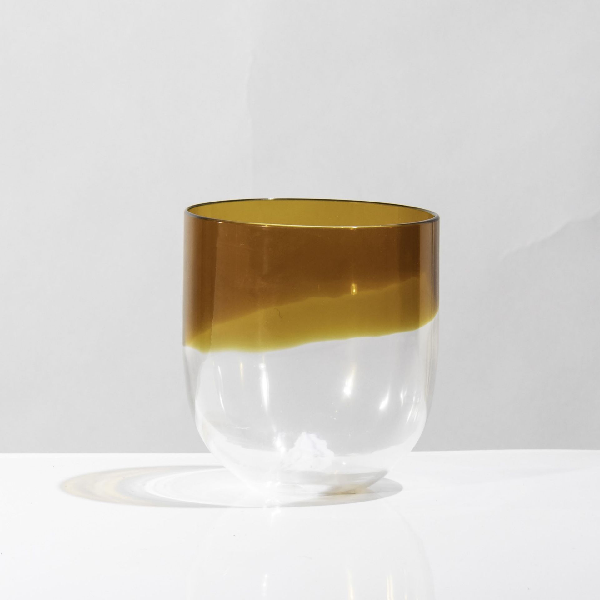 Venini, Murano, 1970 ca - A candleholder in blown glass with an amber band. Signed H [...]