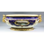 A late 19th Century Coalport bone china oval two-handled jardiniere, the front with oval panel