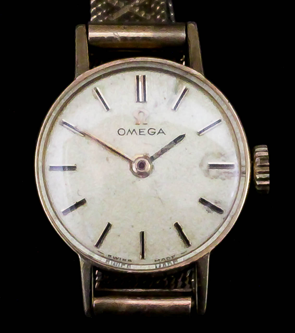 A lady's Omega 9ct gold cased wristwatch, the white dial with gold baton numerals, 24mm diameter,