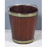 A George III brass bound mahogany peat bucket, the coopered sides with plain brass band to top rim