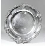 An Edward VII silver circular plate with gadroon shell and leaf cast mounts, 10.5ins diameter, by