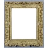 A gilt framed rectangular wall mirror with open leaf scroll frame and inset with bevelled mirror