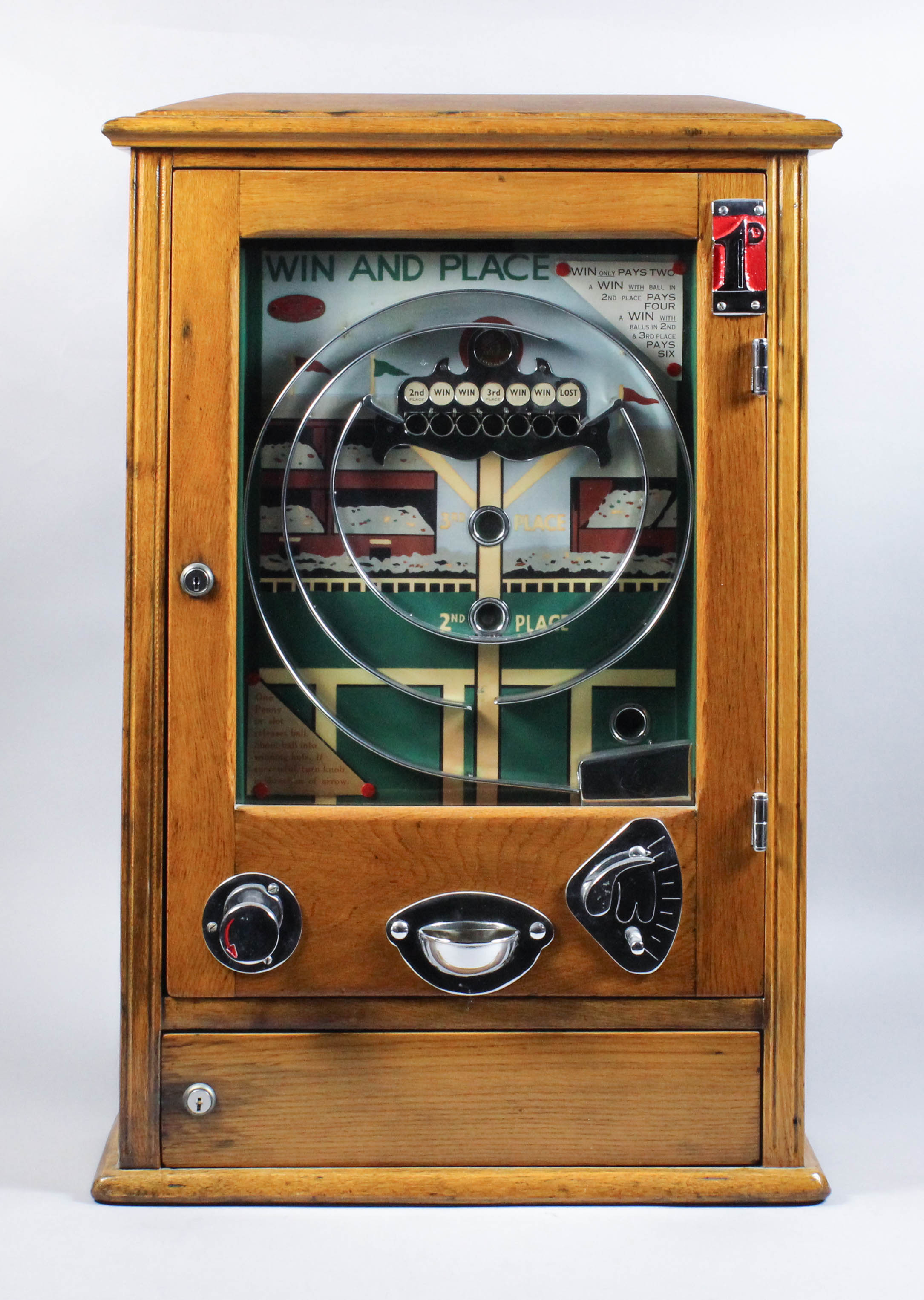 A 1940's oak cased "Win and Place" "Penny-in-the-Slot" Allwin supplied by Ruffler & Walker,