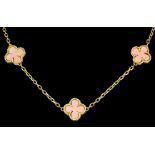 A 20th Century 18ct gold mounted coral necklace, comprising fifteen "clover leaf" coral motifs,