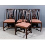 A set of four George III mahogany dining chairs of "Country Chippendale" design with shaped crest