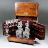 A late 19th Century Continental rosewood liqueur cabinet, the lifting top opening to reveal four