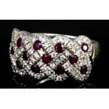 A modern 18ct white gold mounted ruby and diamond ring by Ricardo, the face pave set with fourteen