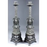 A pair of late 19th Century cast bronze "Roman revival" style candlesticks, the central columns