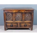 A late 17th /early 18th Century panelled oak mule chest, the plain two plank lid with moulded edge