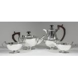 A George VI harlequin silver rectangular four piece tea service with bowed sides, with angular