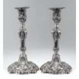 A pair of Victorian silver pillar candlesticks with leaf and scroll cast mounts, the whole