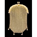 A late 19th/early 20th Century gold coloured metal framed and fine mesh evening purse, the frame