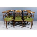 A set of six George IV mahogany dining chairs (including two armchairs) with plain curved crest