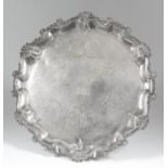 A Victorian silver circular salver, the shaped and moulded rim with shell and scroll cast mounts,