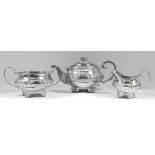 A George IV silver circular three piece tea service with floral and leaf cast mounts, floral