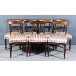 A set of four William IV rosewood dining chairs with plain curved crest rails, scroll carved splats,