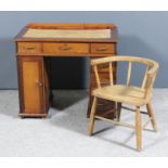 An early 20th Century child's stained wood kneehole desk fitted with cupboard and three drawers to