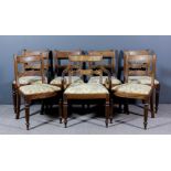 A set of seven George III mahogany dining chairs (including one armchair with scroll arms), the